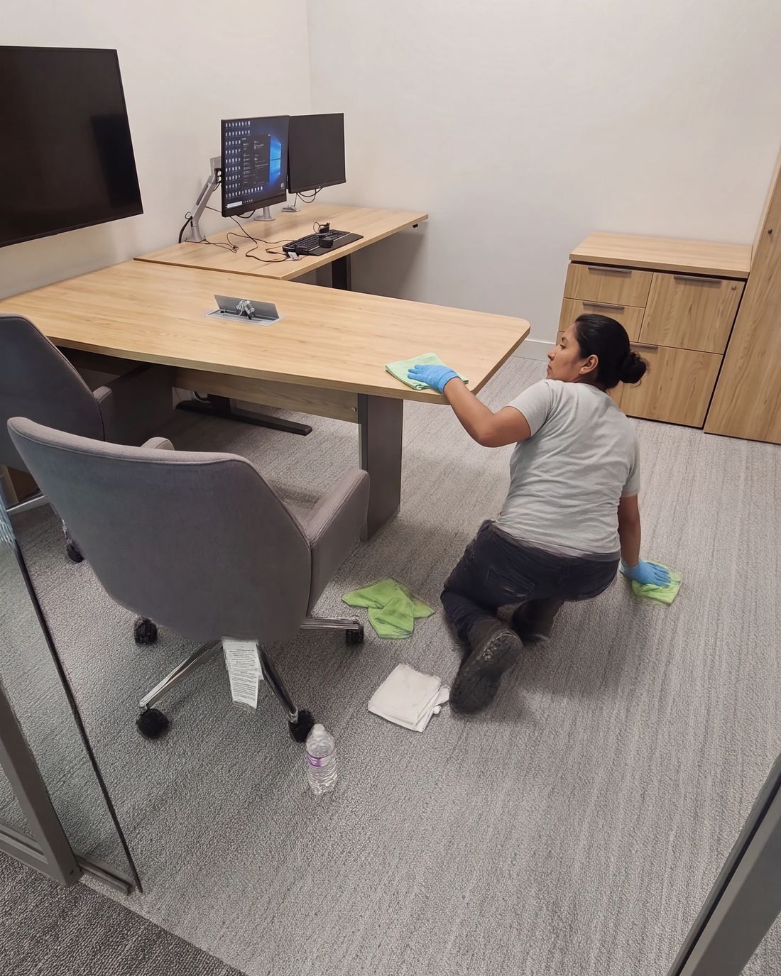 Sano cleaner wiping down an office desk